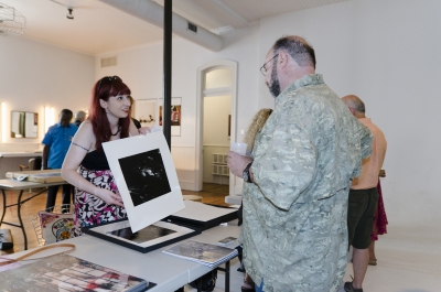 Kimberly Schneider presents her work to fellow photographer - and noted psychologist - Howard Waxman. Photo: Stephen Perloff.