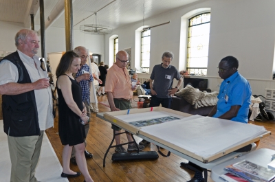 Photographer John Dowell shows his work to (left to right) photographer and dealer Stan Ries, photographers Anna Agoston and Raphael Shaamma, gallerist Laurence Miller, and photographer Richard Kagan. Photo: Stephen Perloff.