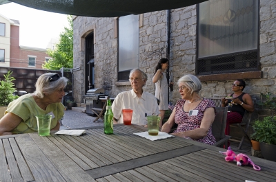 Gwen Gilens (left) converses with photographer Will Brwon and his wife Emily outdoors on the patio. Photo: Stephen Perloff.