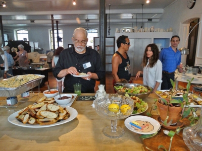 Photographer Ed Vatza samples some of the delicious food provided by Drew Bonacci. Photo: Gary Saretzky.