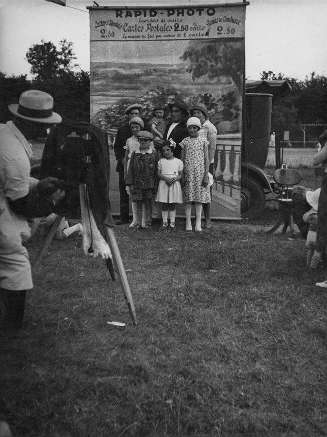 Unknown: Rapid-Photo Photographer Takes Photo of Family in Front of Backdrop, 1930s